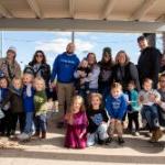 A group of family, friends and kids smile for a photo during Homecoming 2023 on November 2, 2024